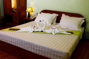 Postel nebo postele na pokoji v ubytování Sandalwood Hotel