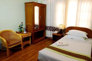 Postel nebo postele na pokoji v ubytování Sandalwood Hotel
