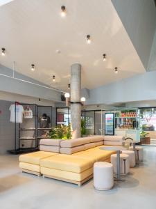 a lobby with couches and tables in a store at Lub d Bangkok Siam in Bangkok