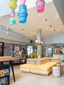 a room with a couch and some colorful lights at Lub d Bangkok Siam in Bangkok