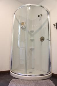 a shower with a glass enclosure in a bathroom at Cabin 2 at Horse Creek Resort in Rapid City