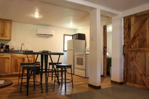 a kitchen with a table and chairs and a refrigerator at Cabin 2 at Horse Creek Resort in Rapid City