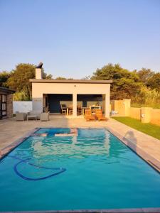 a large swimming pool in front of a house at 391 Vaal de Grace Golf Estate, Parys in Parys