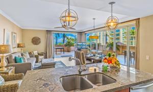 a kitchen with a sink and a living room at Honua Kai 215 2 Bedroom 2 Bath condo in Lahaina