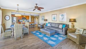 a living room with a couch and a dining room at Honua Kai 215 2 Bedroom 2 Bath condo in Lahaina +31 photos