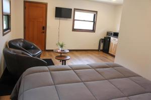 a bedroom with a bed and a living room at Cabin 4 at Horse Creek Resort in Rapid City
