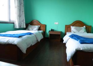 Letto o letti in una camera di Mount Annapurna Guest House