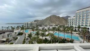 a view of a resort with a mountain in the background at Luxurious apartment at address residences in Fujairah