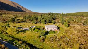an aerial view of a house in a field at MenardsNZ Ecosanctuary Accommodation in Twizel