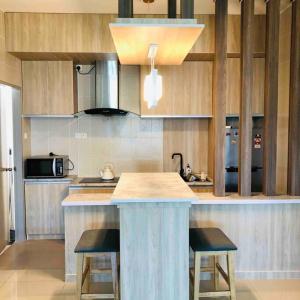 a kitchen with a island in the middle of a kitchen at Maryam’s House (Lovely Seaview apartment ) in Kuala Terengganu