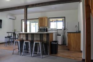 a kitchen with a counter and stools in a room at Cabin 6 at Horse Creek Resort in Rapid City