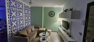 ein Wohnzimmer mit Sofa und Fernseher in der Unterkunft GreenView Alezzi Beach Resort in Mamaia Nord – Năvodari
