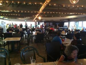 a group of people sitting at tables in a restaurant at Cottage Jasmine on the Shediac Bay with hot tub in Shediac