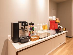 a counter with a coffee maker on top of it at Sotetsu Fresa Inn Daimon in Tokyo