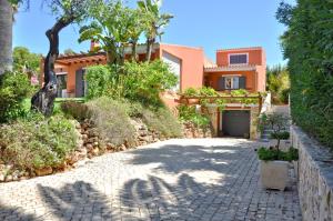 a villa with a driveway in front of a house at Fantastic Private Villa ideal for great family holidays in Quarteira