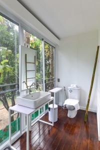 a bathroom with a sink and a toilet at Cochet in Chiang Mai