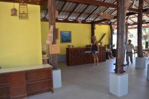 a woman standing in a room with a yellow wall at Koh Yao Noi Beach Resort in Ko Yao Noi