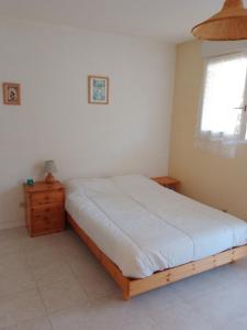 a bedroom with a bed and a dresser and a window at Studio pour cure Eugénie les Bains in Eugénie-les-Bains