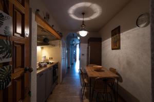 una cocina con mesa y sillas y un pasillo en Appartamento fronte mare con terrazzo zio, en Alassio