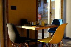 a table with four chairs around it in a room at Arlette Chambres d'Hôtes in Gignod