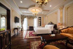 a large bedroom with a bed and a couch at Dream Boutique Hotel in Da Lat