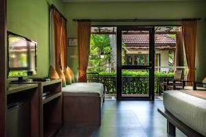 a large room with a bed and a table at Baan Chaweng Beach Resort & Spa - SHA Extra Plus in Chaweng