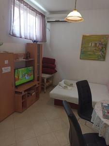 Habitación pequeña con cama y TV. en Apartment Rina - Old Town, en Dubrovnik