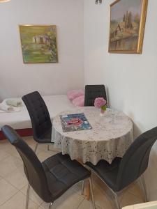 a dining room with a table and four chairs at Apartment Rina - Old Town in Dubrovnik