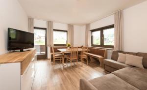 a living room with a couch and a table at Apartments La Rives in Santa Cristina Gherdëina