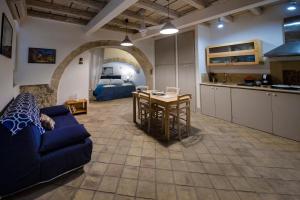 a kitchen and a living room with a couch and a table at Casa Clio in Syracuse