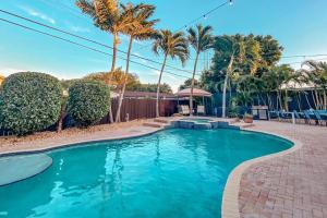 a swimming pool in a yard with palm trees at 5BR! Pool, Air Hockey, Playground, Gazebo, BBQ, Sleeps 16 in Miami