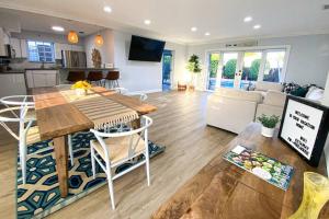 a kitchen and living room with a table and chairs at 5BR! Pool, Air Hockey, Playground, Gazebo, BBQ, Sleeps 16 in Miami