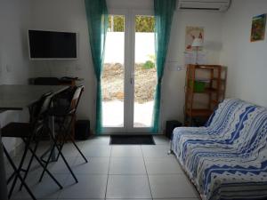 a bedroom with a bed and a table and a window at la belle bleue in Banyuls-sur-Mer