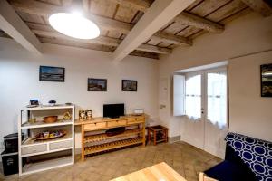 a living room with a table and a television at Casa Clio in Syracuse
