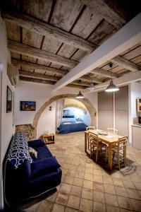 a living room with a blue couch and a table at Casa Clio in Syracuse