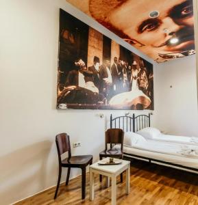 a room with a bed and a poster on the wall at Hostel Franz Ferdinand in Sarajevo