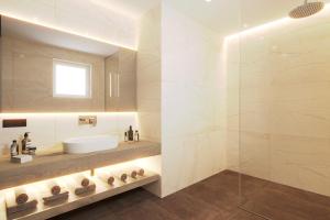 a bathroom with a sink and a glass shower at Maj Luxury Residence in Poreč