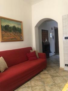 un divano rosso in soggiorno di Casa Serena a Torino