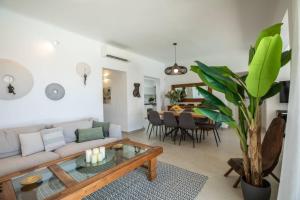 a living room with a couch and a table at Villa Paraga in Platis Gialos