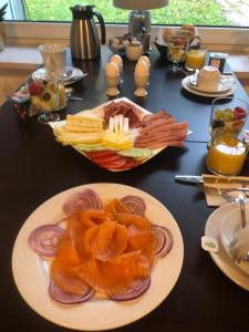 a black table with a plate of food on it at pension-seegarten in Norddeich