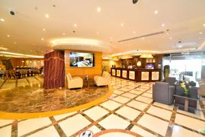 a hotel lobby with chairs and a bar at Emirates Stars Hotel Apartments Dubai in Dubai