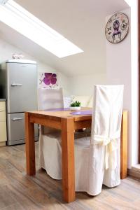 a kitchen with a wooden table and a refrigerator at Apartment LuVi in Korčula