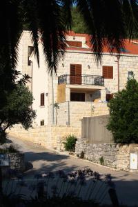 a brick building with a balcony on top of it at Apartment LuVi in Korčula