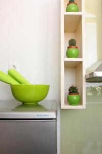 a green bowl sitting on top of a refrigerator at Apartment LuVi in Korčula