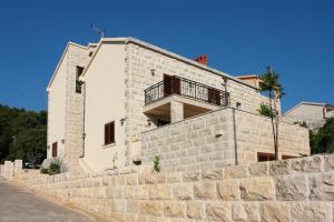 a house on top of a stone wall at Apartment LuVi in Korčula