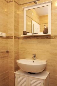 a bathroom with a sink and a mirror at Apartment LuVi in Korčula
