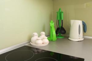 a kitchen counter with white vases on a counter top at Apartment LuVi in Korčula