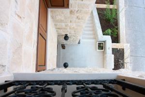an outdoor kitchen with a stove and stairs at Apartment LuVi in Korčula