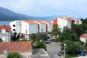 a group of buildings in a town with a parking lot at Apartment LuVi in Korčula