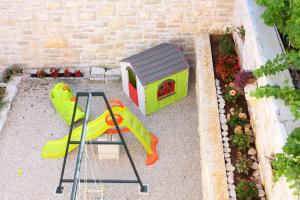 a toy playground with a slide and a dog house at Apartment LuVi in Korčula